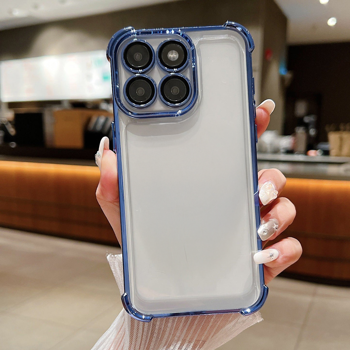Person holding a Motorola Edge 60 Pro 5G phone case with a kitchen background